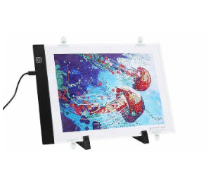 Artist at work on portrait LED Light Drawing Board